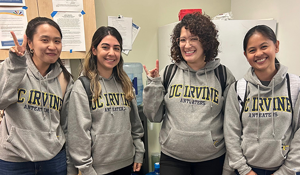 Four students wearing UC Irvine sweatshirts