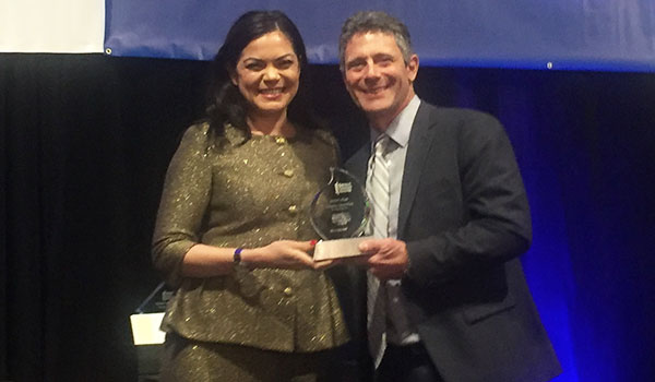 Image of Christina Zabat-Fran receiving her award from John Sganga